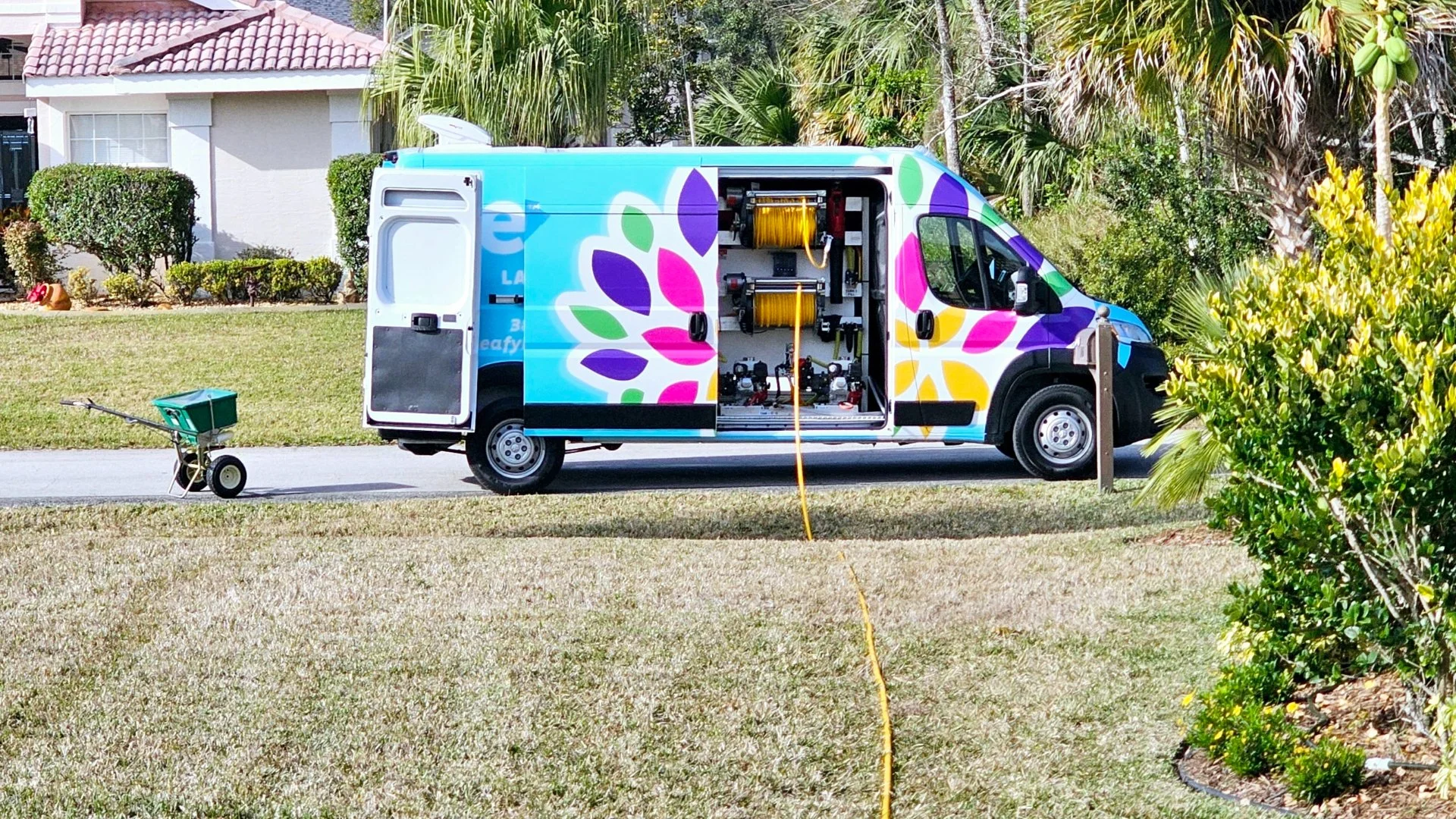 Leafy van with yellow hose on a lawn in New Smyrna Beach, FL