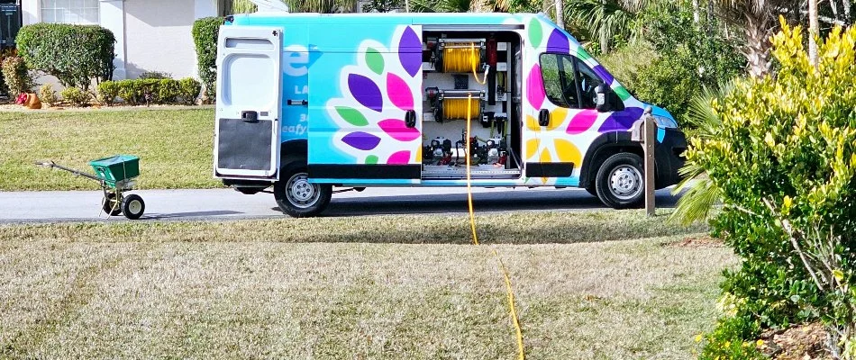 Colorful company van next to a lawn in New Smyrna Beach, FL.