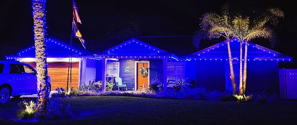 House in New Smyrna Beach, FL, with blue holiday lighting.