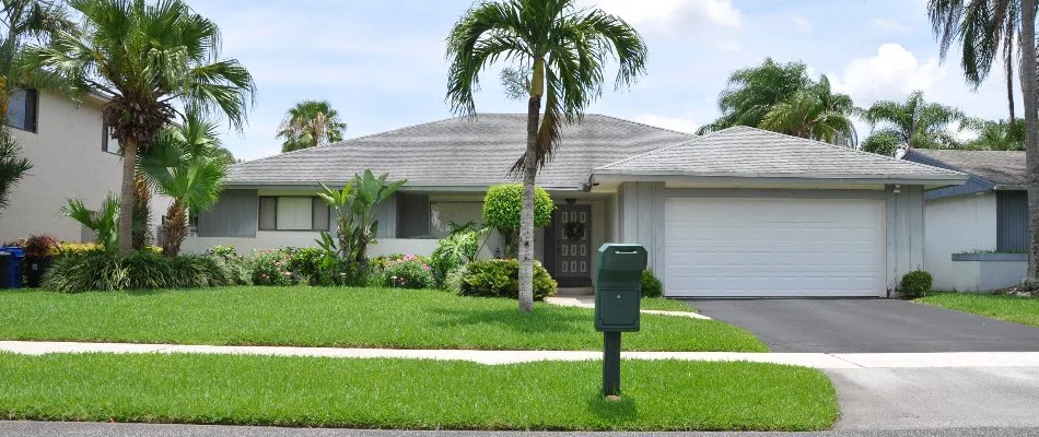 Residential lawn with green mailbox on a property in New Smyrna Beach, FL.